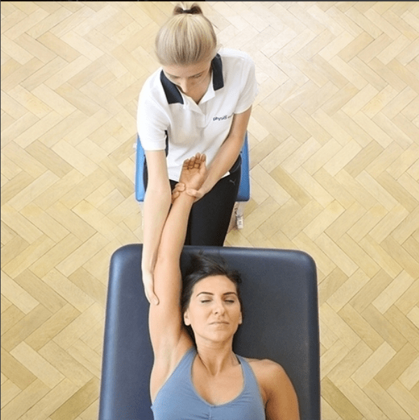 Woman recieving physiotherapy on her arm.