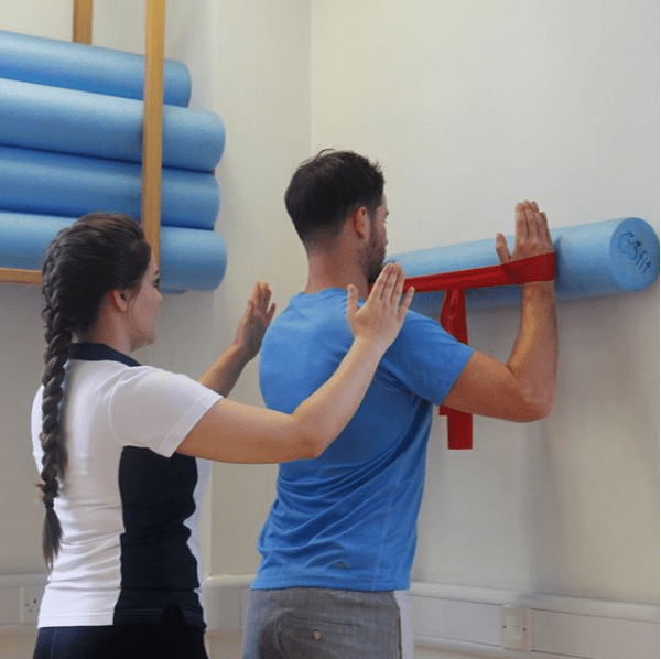 Physiotherapy against a wall.
