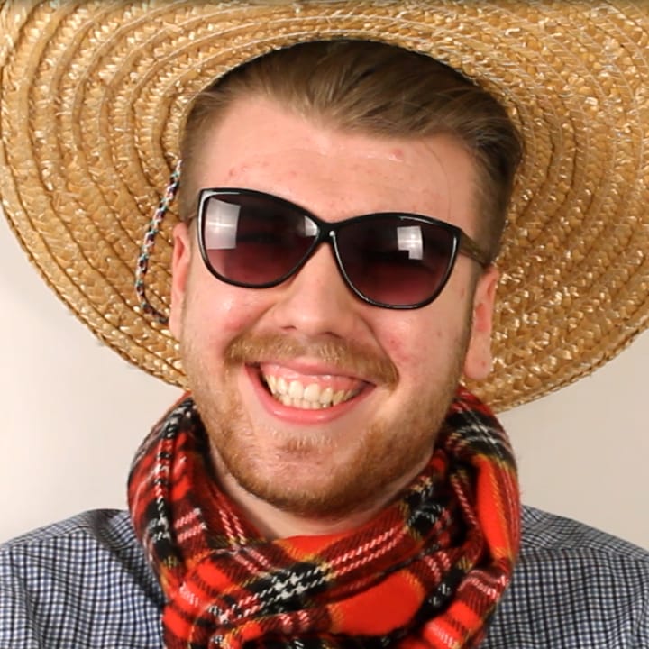 Portrait of Connor wearing sombrero and checkard scarf