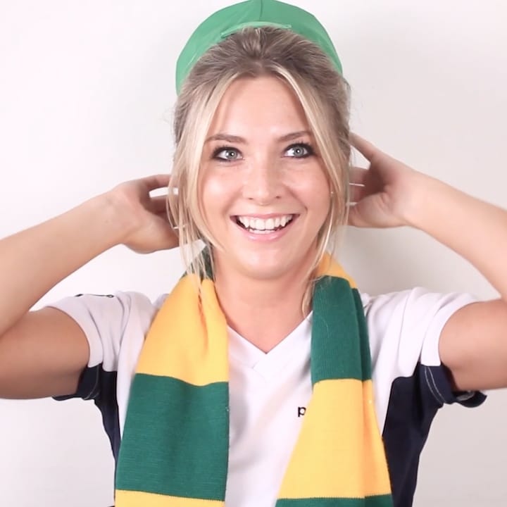 Porttrait of Katie wearing green cap and yellow and green patterned scarf