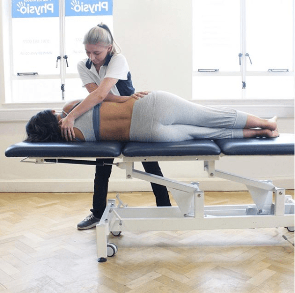 Woman having physiotherapy treatment on her upper back.